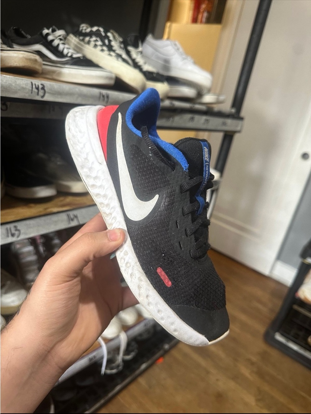 Nike Black Running Shoe with White Swoosh and Blue Lining